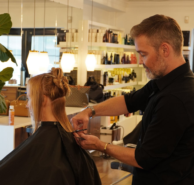 Male hair stylist with female client